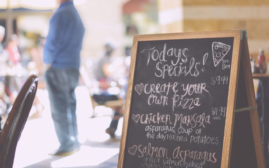 Italian restaurant menu sign showing pizza and chicken specials