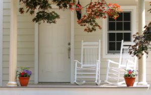 Pair of white rocking chairs sitting on a porch