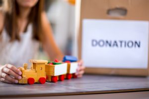 Little girl accepting toy for donation.