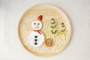 Christmas breakfast snowman pancake with kiwi fruit Christmas trees.