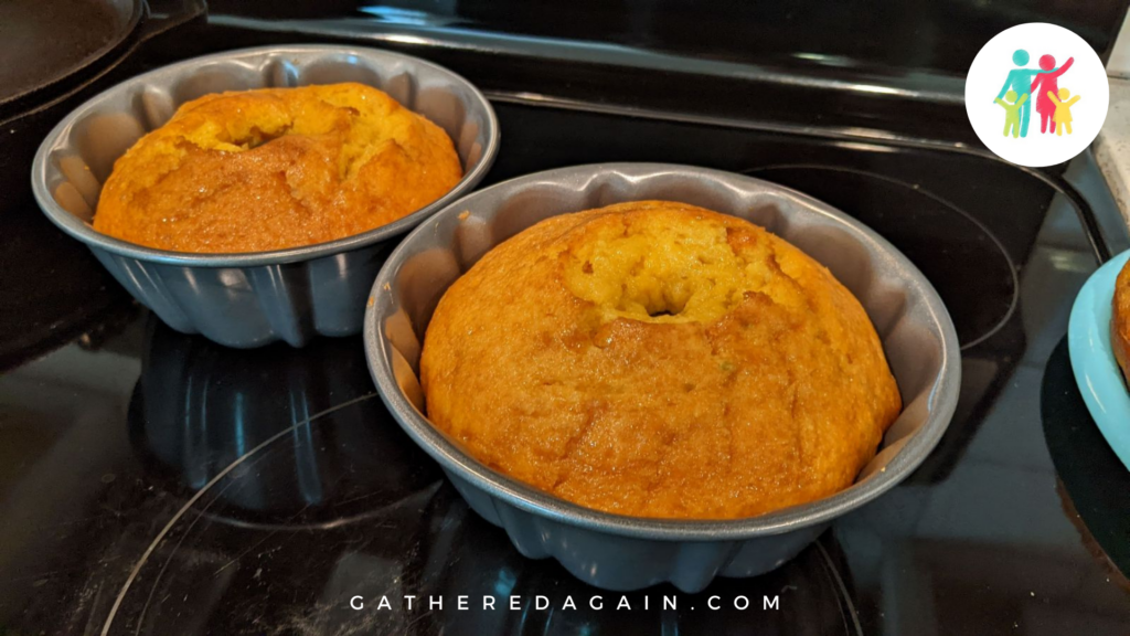 Two non-alcoholic rum cakes still in the bundt cake pans.